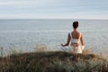 Woman meditating near sea. Space for text Royalty Free Stock Photo