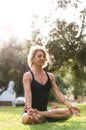 Woman Meditating And Practicing Yoga, Padmasana. Meditation On Sunny Autumn Day At Park. Workout Outdoor. Royalty Free Stock Photo