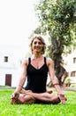 Woman Meditating And Practicing Yoga, Padmasana. Meditation On Sunny Autumn Day At Park. Workout Outdoor. Royalty Free Stock Photo