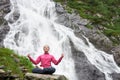 Woman meditating relaxing alone against waterfall Balea Royalty Free Stock Photo