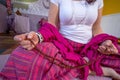 Woman meditating with Rudraksha beads in hands.