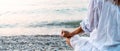 Woman meditating at the sea