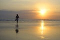 Woman meditating and thinking peacefully in yoga pose on desert beach on sunset in meditation and freedom Royalty Free Stock Photo