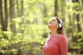 Woman meditating wearing headphones in a forest Royalty Free Stock Photo
