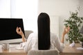 Woman meditating at workplace in office, back view Royalty Free Stock Photo