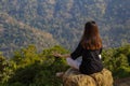 Woman meditating yoga at mountains, practices meditation, serenity, Lifestyle relaxation, Emotional, Outdoor harmony with nature Royalty Free Stock Photo