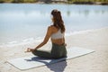 Woman Meditating in Yoga pose on the Beach Royalty Free Stock Photo