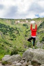 Woman meditating in yoga pose in front of mountain lake Royalty Free Stock Photo