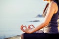 The woman meditating in a yoga pose on the tropical beach. Femal Royalty Free Stock Photo