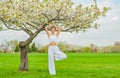 Woman meditating in yoga vrksasana tree pose at the park Royalty Free Stock Photo