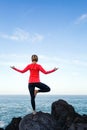 Woman meditating in yoga vrksasana tree pose Royalty Free Stock Photo