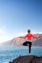 Woman meditating in yoga vrksasana tree pose Royalty Free Stock Photo