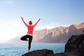 Woman meditating in yoga vrksasana tree pose Royalty Free Stock Photo