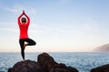 Woman meditating in yoga vrksasana tree pose Royalty Free Stock Photo