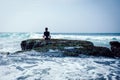 Woman meditation at the seaside croal cliff edge