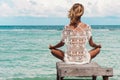 Woman meditation in a yoga pose at the beach Royalty Free Stock Photo
