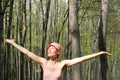 Woman meets sun in the forest Royalty Free Stock Photo