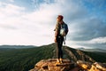 A woman meets the sunset in the mountains. Man travels in the mountains. Mountain tourism. The journey to the mountains. Royalty Free Stock Photo