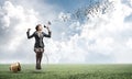 Woman with megaphone sitting on big light bulb