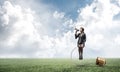 Woman with megaphone sitting on big light bulb