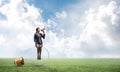 Woman with megaphone sitting on big light bulb