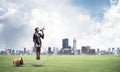 Woman with megaphone sitting on big light bulb Royalty Free Stock Photo