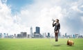 Woman with megaphone sitting on big light bulb