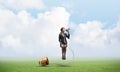 Woman with megaphone sitting on big light bulb Royalty Free Stock Photo