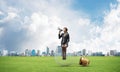 Woman with megaphone sitting on big light bulb Royalty Free Stock Photo