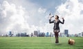 Woman with megaphone sitting on big light bulb Royalty Free Stock Photo