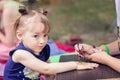 Woman mehendi artist painting henna on the child`s hand