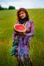 Woman with melon hands in beautiful ornamental dress. Royalty Free Stock Photo