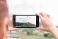 Woman is memorizing a video on her phone. Technology concepts make life easier wherever you are. Royalty Free Stock Photo