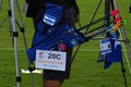 Woman and men aiming to a target in a archery competition