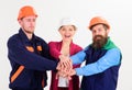 Woman and men in hard hats holds hands together. Royalty Free Stock Photo