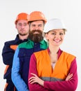 Woman and men in hard hats stand close as team. Royalty Free Stock Photo