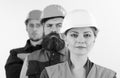 Woman and men in hard hats stand close as team. Royalty Free Stock Photo