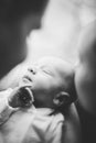 Woman and man holding on hands a newborn. Mom, dad and baby. Mother kissing her son. Happy family life. Man was born Royalty Free Stock Photo