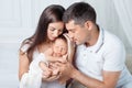 Woman and man holding a newborn. Mom, dad and baby. Close-up. Portrait of  smiling family with newborn on the hands. Happy family Royalty Free Stock Photo