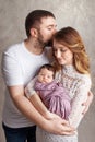 Woman and man holding a newborn. Mom, dad and baby. Portrait of  smiling family with newborn on the hands. Happy family concept Royalty Free Stock Photo