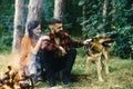 Woman and man on vacation, enjoy nature. Couple in love, young happy family spend leisure with dog. Royalty Free Stock Photo