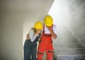 Woman and man workers suffocating at the construction site. Royalty Free Stock Photo