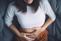 Woman with menstrual cramps clutching stomach in pain Royalty Free Stock Photo