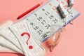 Woman menstrual cup, tampons, calendar, control of the regular cycle, pencil and sanitary pad napkin with a question