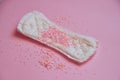 Woman menstrual pad with pink glitters