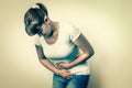 Woman with menstrual pain is holding her aching belly Royalty Free Stock Photo