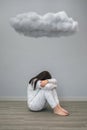 Woman with mental disorder and suicidal thoughts crying under a dark cloud Royalty Free Stock Photo