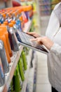 Woman merchandiser using tablet Royalty Free Stock Photo