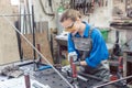 Woman in Metal workshop with tools and workpiece Royalty Free Stock Photo