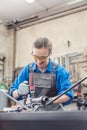 Woman in Metal workshop with tools and workpiece Royalty Free Stock Photo